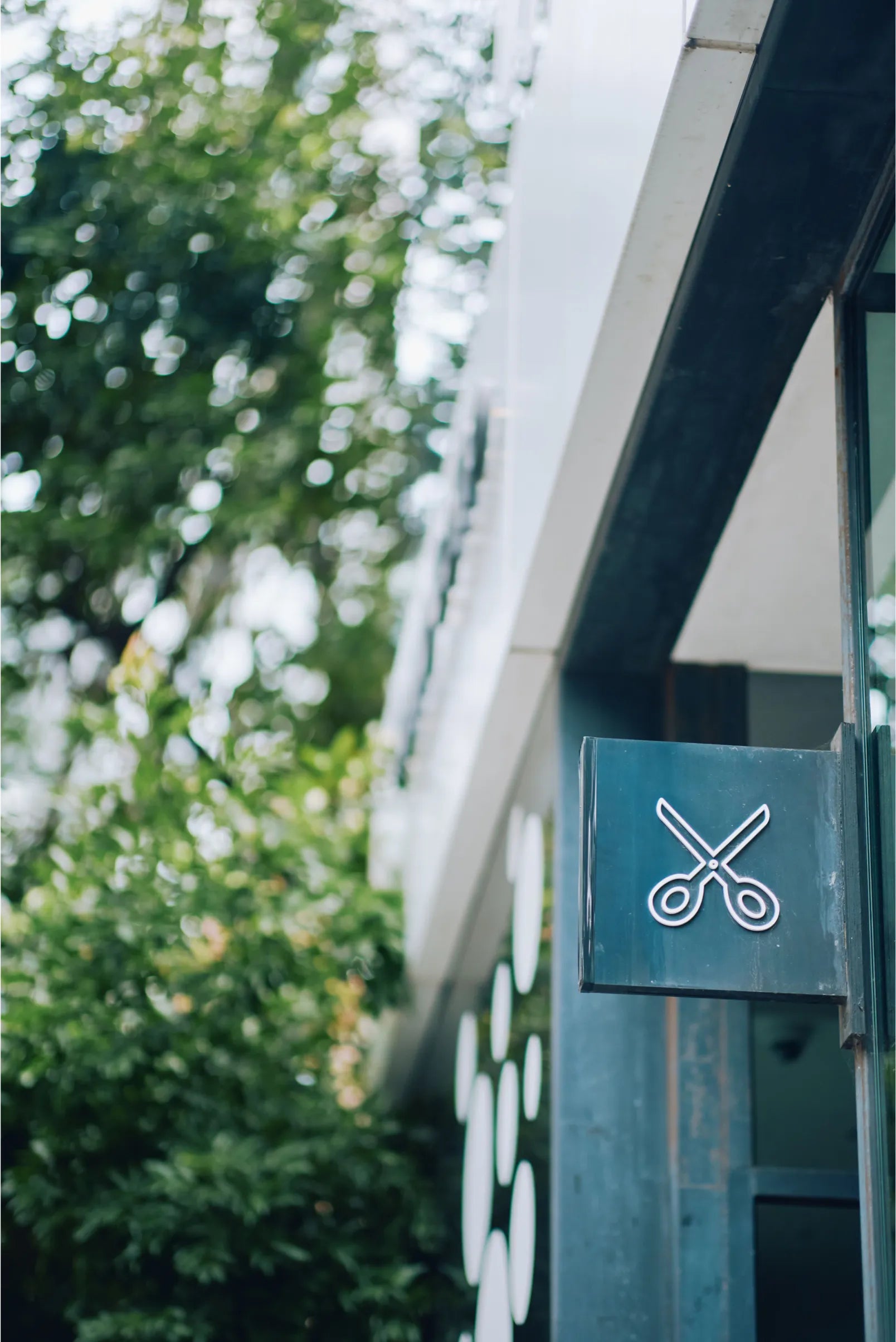 SHHH salon scissors sign on storefront exterior